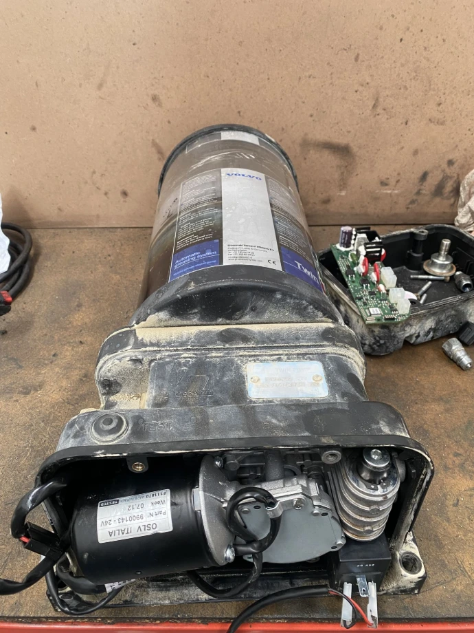 Automatic greasing pump being inspected for repair